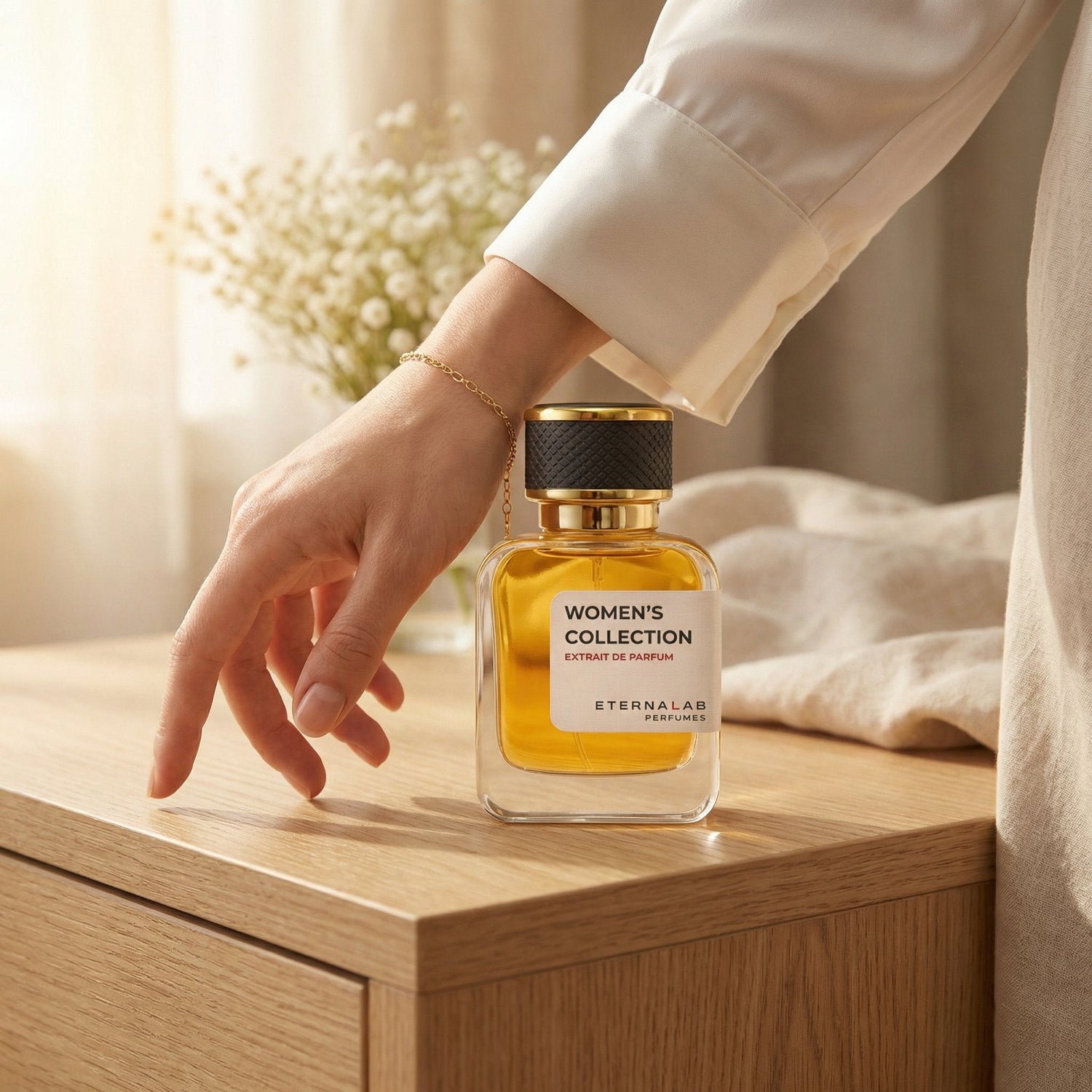 Eterna Lab Women's perfume bottle on warm oak wood, woman's hand with silk cuff and gold bracelet, elegant and soft feminine fragrance aesthetic with golden morning light.