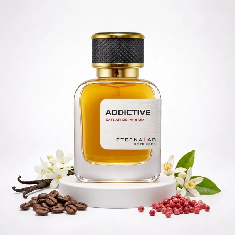 Eterna Lab Addictive Extrait de Parfum bottle on a pedestal, surrounded by vanilla, coffee, neroli flowers, and pink peppe...
