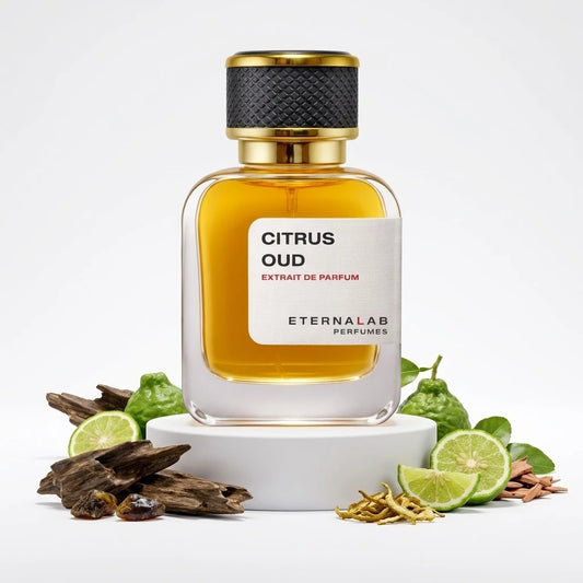 Eterna Lab Citrus Oud perfume bottle displayed with bergamot fruits, sliced lime, dark oud wood, and amber.