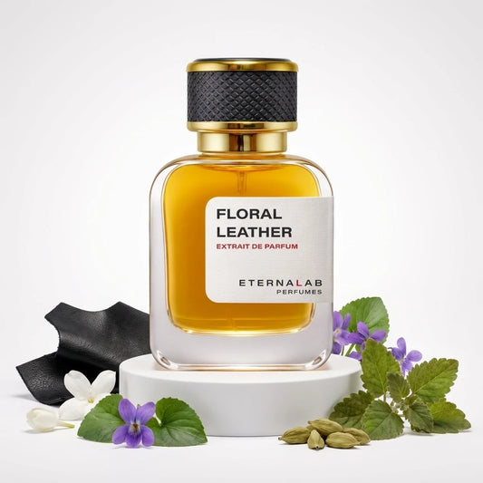 Eterna Lab Floral Leather Extrait de Parfum bottle alongside black leather, white jasmine, violets, and green cardamom pods.