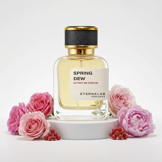 Eterna Lab Perfumes Spring Dew Extrait de Parfum bottle surrounded by pink roses, light purple peonies, and red berries.