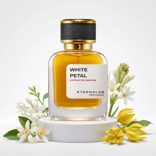 Eterna Lab White Petal Extrait de Parfum bottle surrounded by white tuberose, orange blossom, and yellow ylang-ylang flowers.