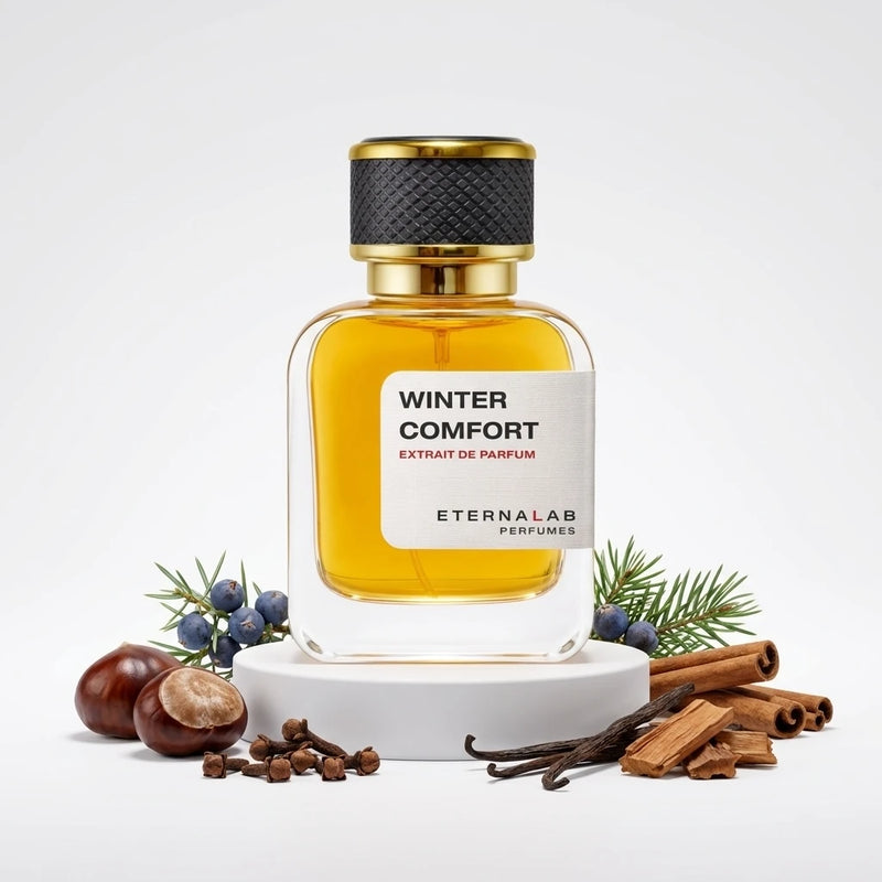 Eterna Lab Winter Comfort perfume bottle surrounded by chestnuts, cloves, vanilla beans, juniper, and cinnamon.